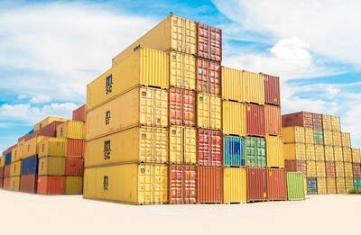 A pile of storage containers on a dock | debt collector Michigan
