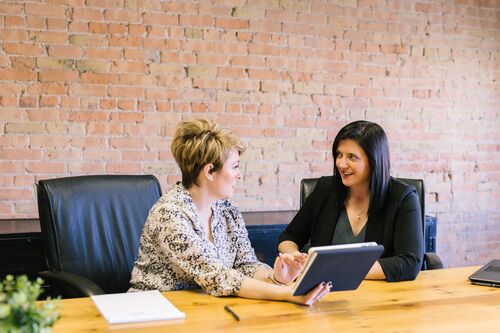 Two office workers meeting | Collection agency Muskegon